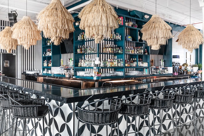 House of Nomad used the combination of black and white and pops of color to curate a care-free restaurant design style.