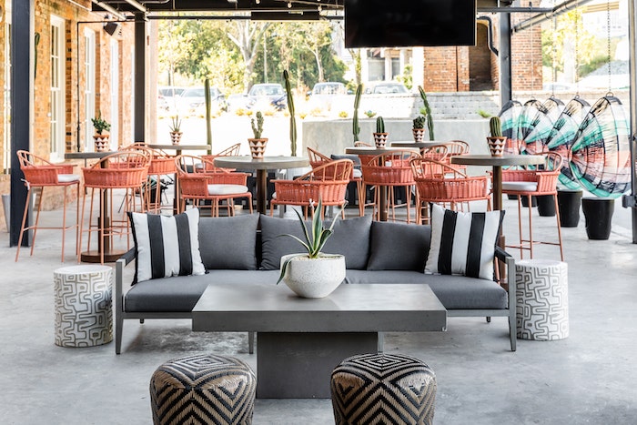 Sunbrella throw pillows in a bold black and white stripe are an eye-catching addition to this outdoor lounge area.