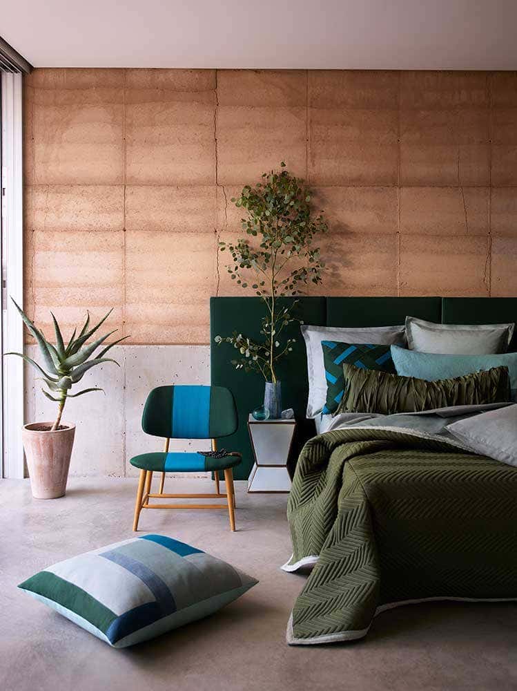 Bedroom with plant décor and green Sunbrella fabric