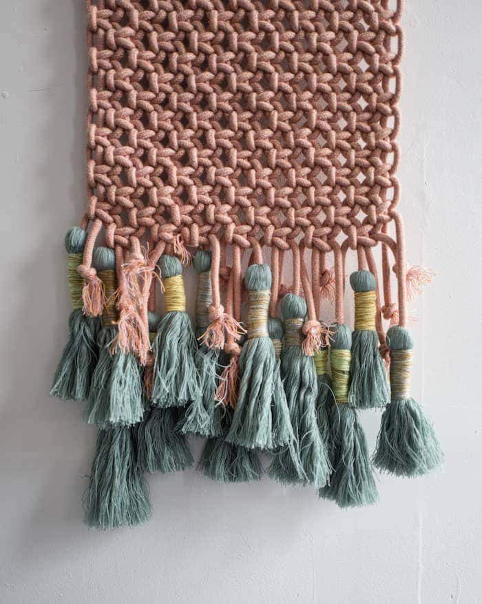 Textile wall décor with tassels made out of Sunbrella fabric