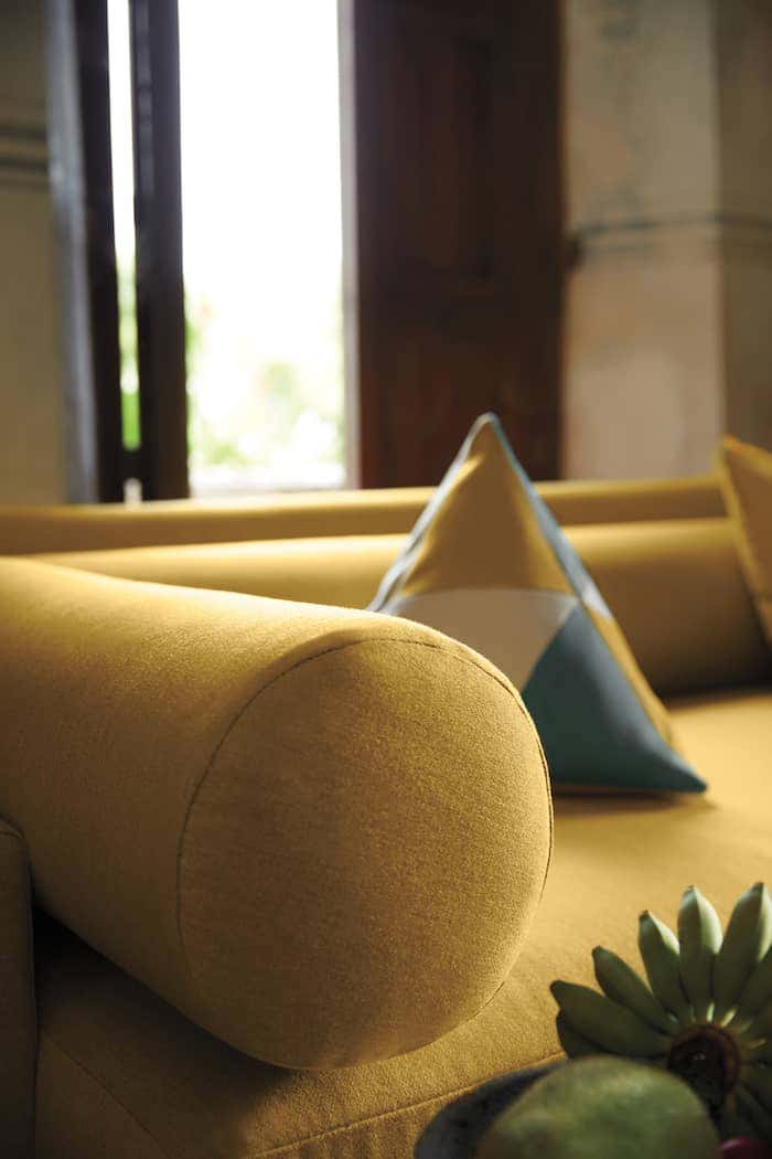 Modern couch upholstered in yellow Sunbrella fabric