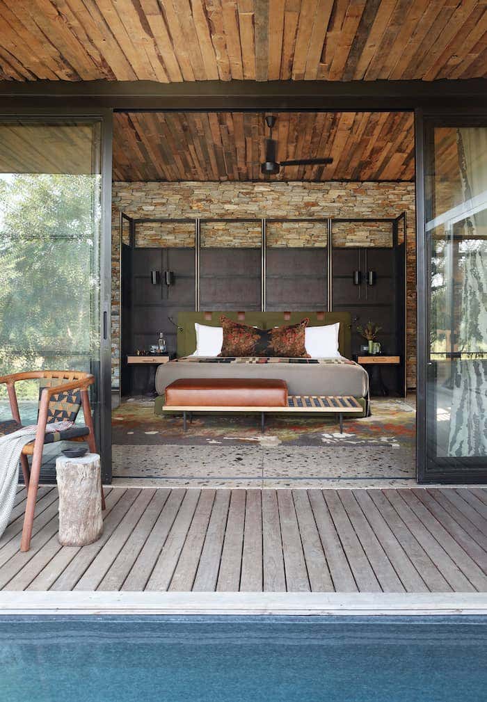 Open concept bedroom design with wood ceiling and flooring to create an indoor outdoor living space