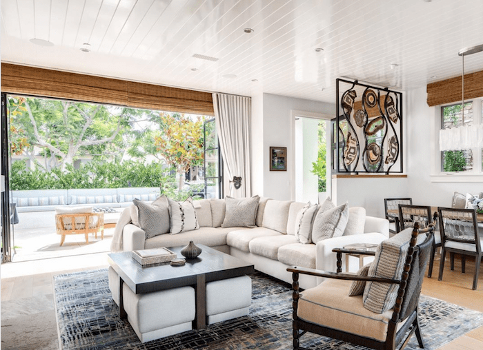 Open concept home office design with floor to ceiling windows and white Sunbrella drapery to create an indoor outdoor room