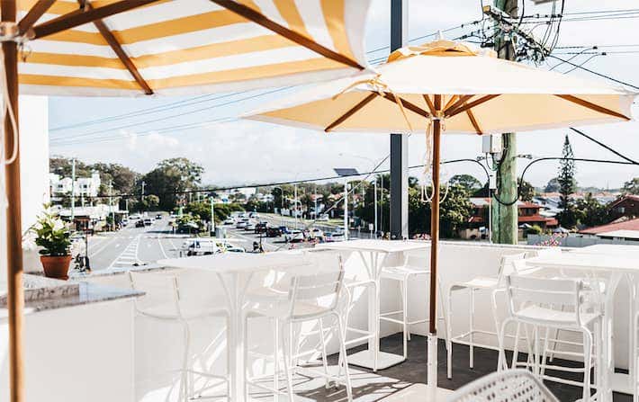 rooftop restaurant with yellow and white umbrellas