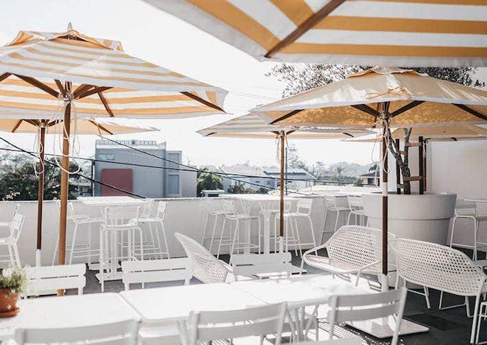 restaurant with yellow and white awnings