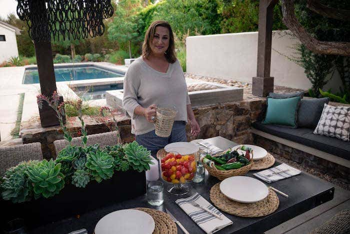 Anne Michaelsen has an eye for entertaining in style; Blue-toned Sunbrella performance fabrics complete this built-in outdoor dining space.