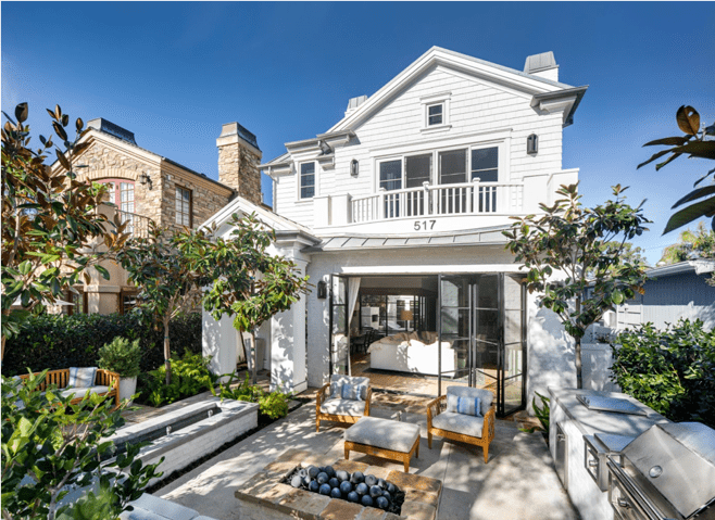 This gorgeous coastal courtyard features true comfort with soft gray Sunbrella upholstered chairs and ottoman.