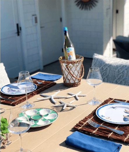 Anne Michaelsen’s fun and beachy tablescape with starfish, seashells, and Sunbrella throw pillows.