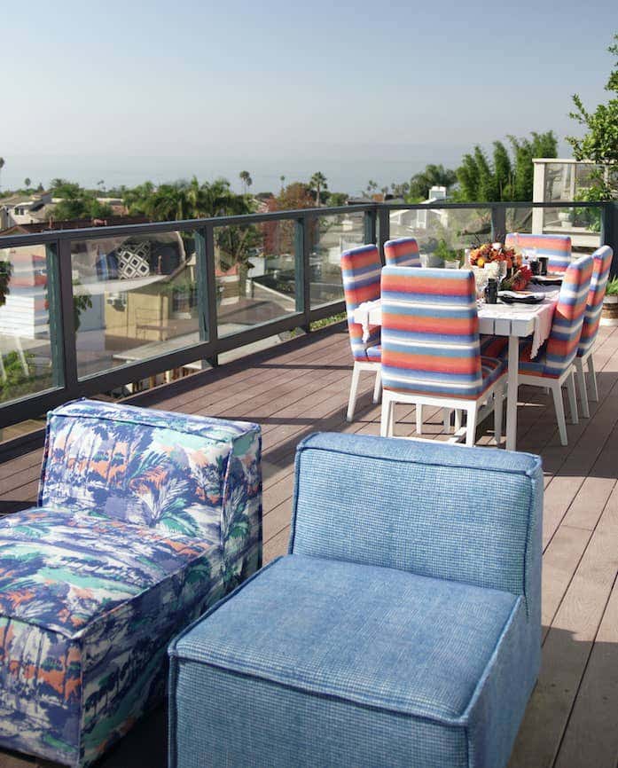 Bold and colorful Sunbrella textiles brighten this rooftop entertaining space, highlighting Fiesta Key upholstery