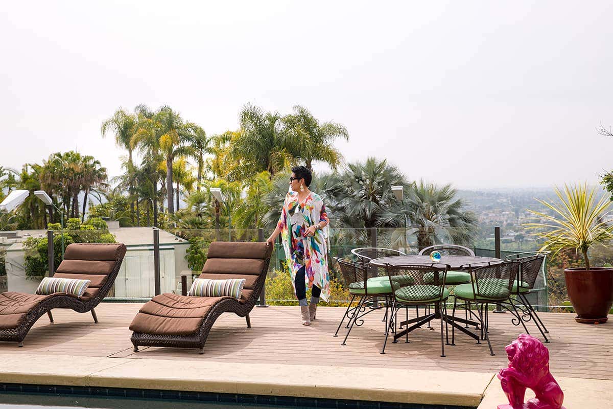 Rachel Moriarty overlooks the San Diego skyline from a poolside terrace, upholstered in bright Sunbrella fabrics