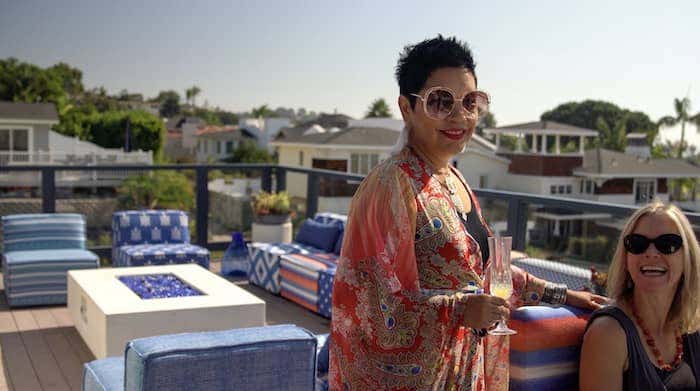 Rachel and her client admire the newly redesigned rooftop, highlighting 15 different bold Sunbrella patterns