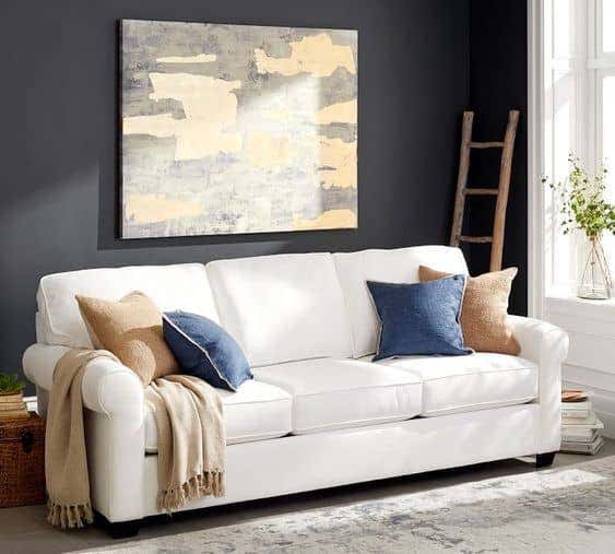 The Buchanan Roll Arm Upholstered Sofa from Pottery Barn with Sunbrella performance fabric is the perfect addition to a kid friendly living room.