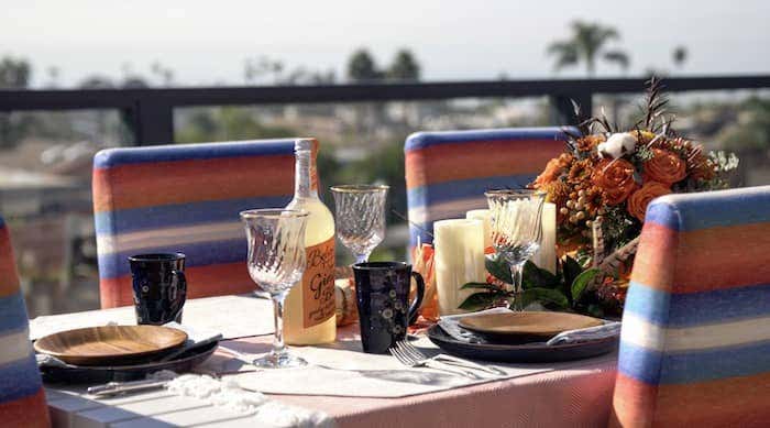 Sunbrella performance table runner in Cast Silver provides a neutral anchor for this autumnal table decor, while offering much needed stain resistance