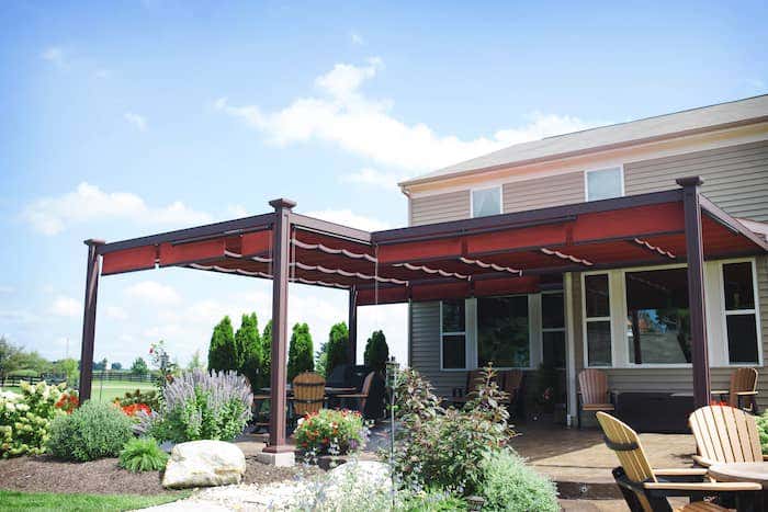 A shade structure from ShadeTree with Sunbrella fabrics extends the comfort and coolness of an indoor space for your yard or patio while creating dimension and polished style.