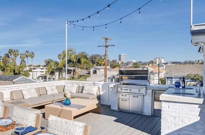 An outdoor living room and dining space complete with Sunbrella fabrics turn your porch or patio into a comfortable and cozy extension of your indoor living spaces.