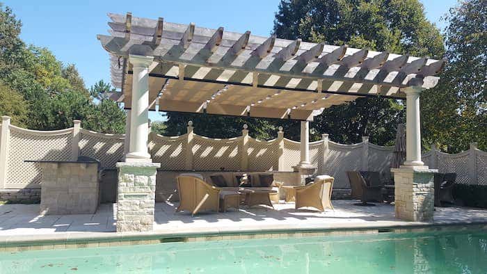 This poolside pergola with a neutral Sunbrella fabric creates the ultimate shaded sanctuary for family and friends lounging after a swim in the pool, making it one of our top backyard shade solutions for this season!