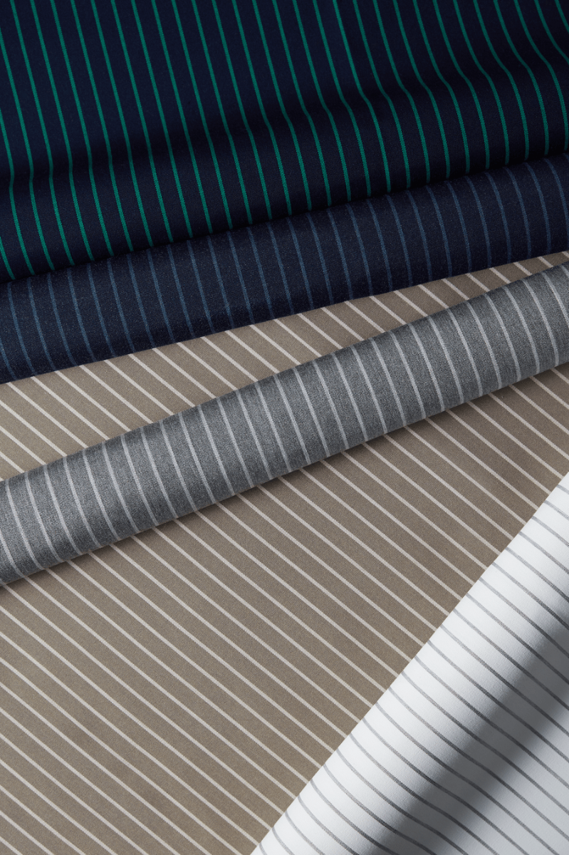 Luxurious striped fabrics from Sunbrella’s Dimension Collection, featured in Indigo, Prep, Smoke, and Taupe.