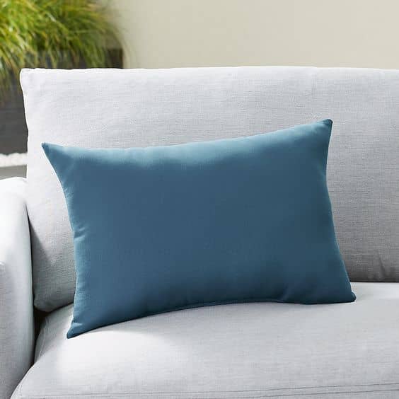 The solid outdoor Lumbar Pillow from Crate & Barrel features Sunbrella fabrics that adds an element of durability and softness to your outdoor patio furniture set.