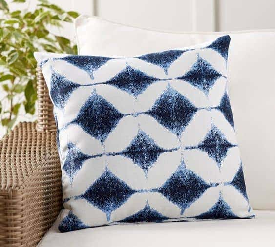 Bold patterns like the Sunbrella Shelton Jacquard pillow from Pottery Barn add punchy, bold interest to a neutral outdoor furniture palette.