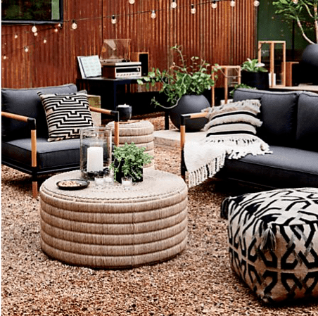 Backyard patio design with a teak wood outdoor furniture set with charcoal Sunbrella outdoor upholstery fabric