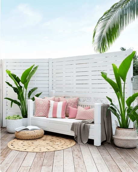 Coastal outdoor patio design with pink Sunbrella pillows