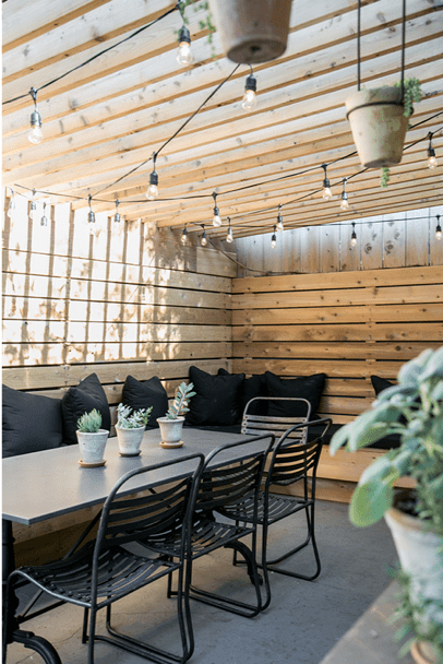 Small patio decorating idea with black pillows in Sunbrella indoor outdoor upholstery fabric 