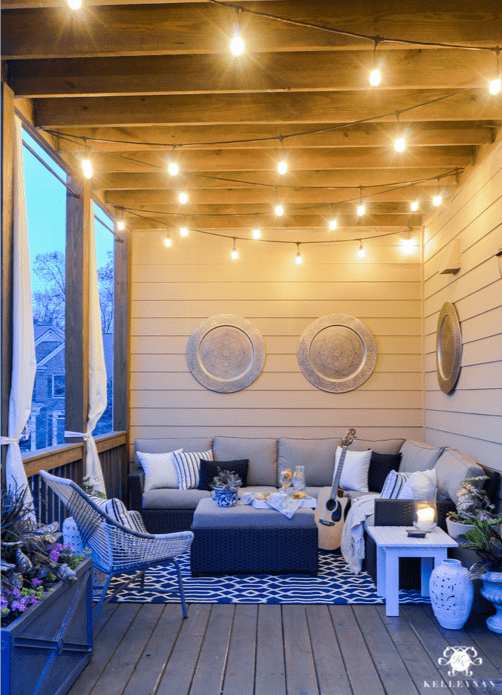 Small outdoor patio idea with hanging lights and outdoor furniture in Sunbrella upholstery fabric