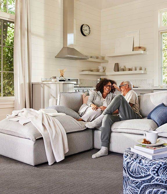 Couple sitting on sofa enjoying life