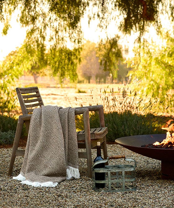 Relaxing outdoor setting with a Sunbrella throw