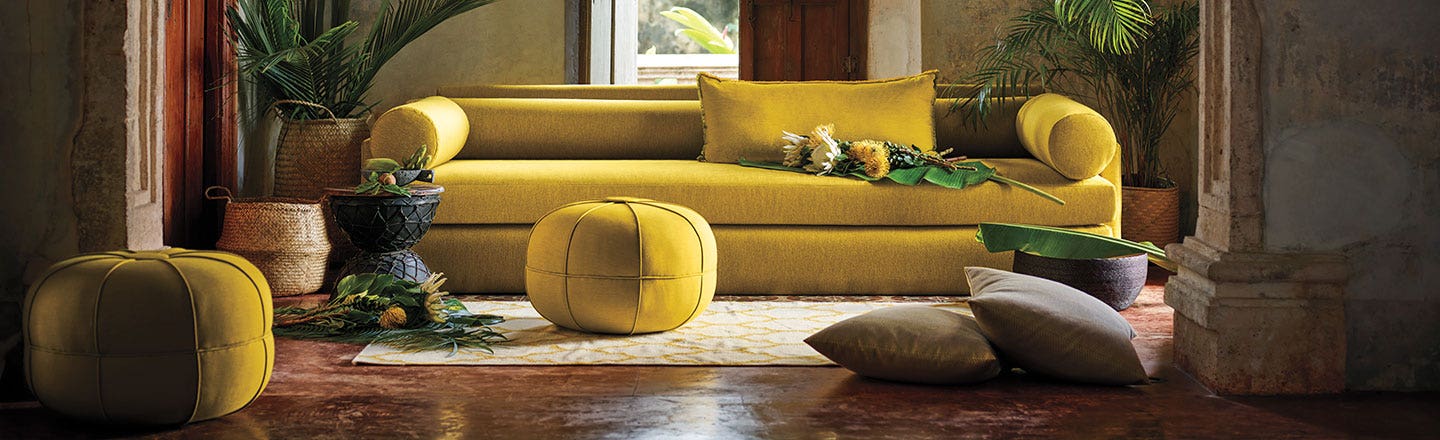 modern mustard couch with ottomans and pillows