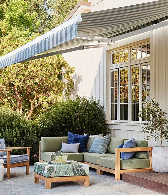 An outdoor patio set with a couch, chair, and center table