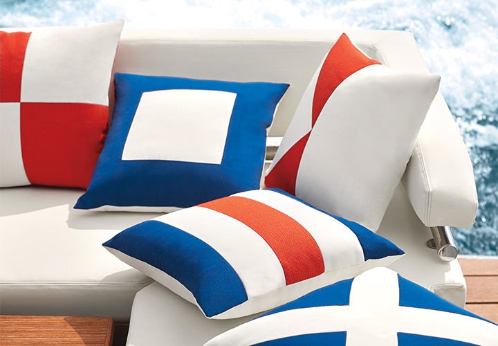 White, orange, and blue pillows on a boat couch