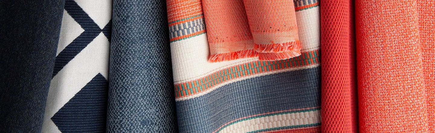 Orange and blue patterned woven fabrics hanging