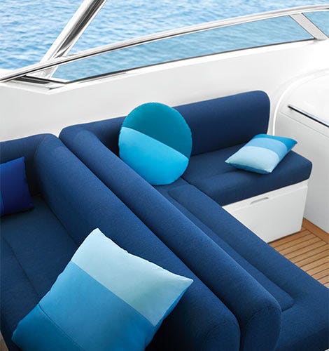 Blue boat sofa with blue pillows