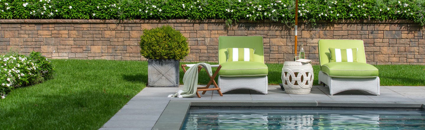 Green cushions on poolside patio furniture